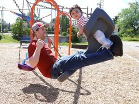 Thomas Decosse entertains his son, Jude, 1, on the swings at the Lively Playground in Lively, Ont. on Friday July 30, 2021. John Lappa/Sudbury Star/Postmedia Network