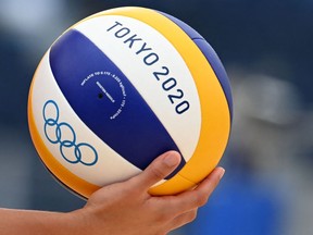 Canada's Melissa Humana-Paredes prepares to serve the ball in their women's preliminary beach volleyball pool A match between Canada and Germany during the Tokyo 2020 Olympic Games at Shiokaze Park in Tokyo on July 26, 2021. Columnist Ruth Farquhar says rules about what women volleyball players must wear are sexist. ANGELA WEISS/AFP via Getty Images