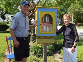 Glen and Joan Brown stand in front of their Mooretown Little Free Library, which they installed in August 2019. The Browns said local families and nearby campers are big users of their little literary outpost. Carl Hnatyshyn/Sarnia This Week