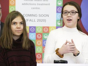 Maura Cook, left, and Janessa Labadie, right, members of the youth committee of Sarnia's Access Open Minds Centre, speak at a gathering at 190 Front St. in December 2019. A 50/50 lottery is being launched to raise funds for the youth centre. 
File photo/Postmedia Network
