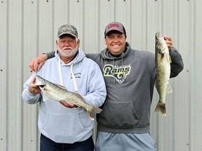 Larry Wellington (left) and Chris Abram pose with their walleye in 2019 at the Bluewater Anglers hatchery in Point Edward. The angling club's walleye derby is making its return Aug. 6 and 7. It's the first event the club has held in two years, an organizer says. Submitted