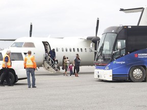 Pikangikum First Nation evacuees began arriving at Timmins Victor M. Power Municipal Airport last Wednesday afternoon after being forced to flee their Northwestern Ontario community due to forest fires raging in that part of the province. After getting off the plane, the residents began boarding buses to be transported to Ramada Inn.

RICHA BHOSALE/THE DAIILY PRESS