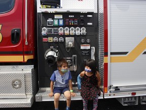 Jayvin Turtle and his sister Jaylin were among the youngsters who came to inspect the Timmins fire truck during the Touch the Truck event hosted by different community emergency services at Ramada Inn on Monday. Many of those who attended were children and families that were welcomed in Timmins as fire evacuees from Pikangikum. Different emergency vehicles were displayed at the event allowing those children an opportunity to take a look over them. 

RICHA BHOSALE/The Daily Press