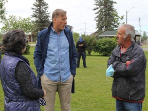 People's Party of Canada leader Maxime Bernier, centre, met one-on-one with a number of people who showed up to hear him speak at Anson Park in Iroquois Falls Friday morning including Jean and Lucien Jolin. RON GRECH/The Daily Press