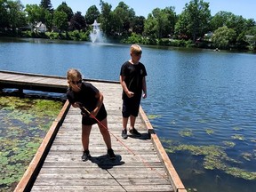 Two youngters enjoy fishing from the Lake Lisgar boardwalk during the annual July 3-11 Tillsonburg Family Fishing Derby, a virtual event this year. (Submitted)