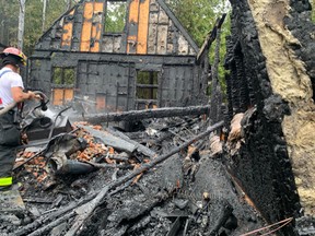 Smoke alarms awoke a husband and wife early Tuesday morning to a "huge orange glow" as their cottage burned. The couple was able to make it out safely, but the Tobermory cottage was destroyed. Photo supplied by Northern Bruce Peninsula Fire and Emergency Services.