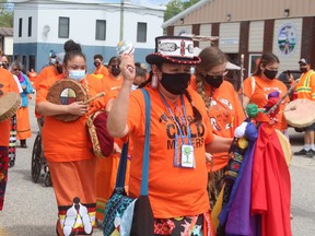 Co-organizer Charlene Echum begins the emotional march. She carries flags that will be offered in the fire as part of the closing ceremonies..TP.JPG