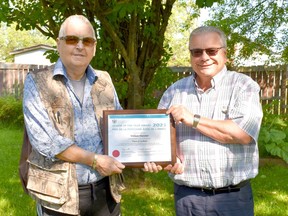 William “Bill” Heavener receives the provincial Senior of the Year Award for 2021 from Mayor Denis Clement. The award goes to seniors over 65 who contributes to their community.