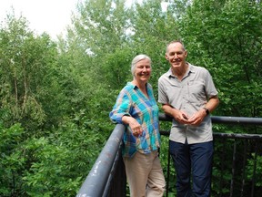 Shawna Macivor and Lloyd Lewis of NeighbourWoods North stand in front of a backdrop of trees at the Centennial Tower in Owen Sound Tuesday. The pair, along with fellow organization member Gord Edwards, asked the city to apply to become a Tree City of the World. DENIS LANGLOIS