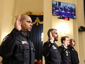 U.S. Capitol Police officer Sgt. Aquilino Gonell, DC Metropolitan Police Department officer Michael Fanone, DC Metropolitan Police Department officer Daniel Hodges and U.S. Capitol Police officer Harry Dunn are sworn-in before testifying before the House Select Committee investigating the Jan. 6 attack on Capitol Hill in Washington.