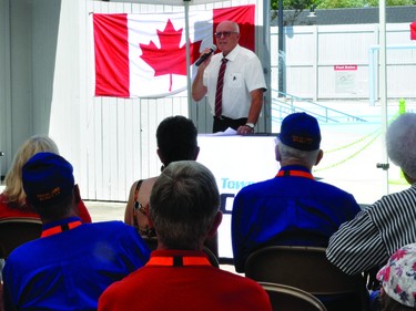 With the new pool behind him, Tom Grant, Vulcan's mayor, talked about the history of Vulcan's pools and the cost of building the Vulcan Lions Community Pool.