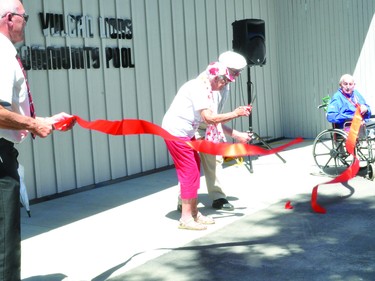 Marjorie Stephen and Gene Waskiewich cut the ribbon on Canada Day to officially open the Vulcan Lions Community Pool. Holding the ends of the ribbon are Vulcan Mayor Tom Grant and Vulcan Lion Jerry Wylie.