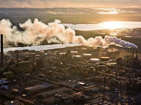 The setting sun reflects off a tailings pond behind Syncrude's oilsands upgrading facility north of Fort McMurray.