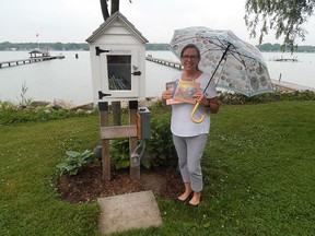 Port Lambton's Anne Hazzard showcases her Little Free Library, which sits nestled along the St. Clair River. The well-used library is a hotspot as well as a destination for many local book lovers, she said. Carl Hnatyshyn/Postmedia Network