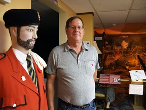 Henry VanHaren, president of the Wallaceburg & District Museum, is photographed next to a recently-acquired Legion Colour Guard uniform July 21, 2021. The museum will reopen to members July 27 and to everyone July 28.