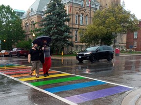 Murphy Boyse, right, a member of the local LGBT2G+ community, and Alicia Malcolm, an ally, celebrate the city's new rainbow crosswalk installed this week on Talbot Street by city hall.Eric Bunnell