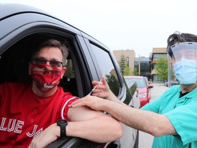 Grey-Bruce Medical Officer of Health Dr. Ian Arra volunteered during a Canada Day drive-through COVID-19 vaccine clinic outside of the health unit in Owen Sound. Arra is pictured here with Bruce-Grey-Owen Sound MPP Bill Walker.