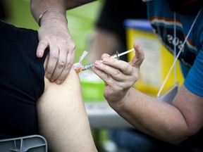 A shot of Moderna vaccine being administered.