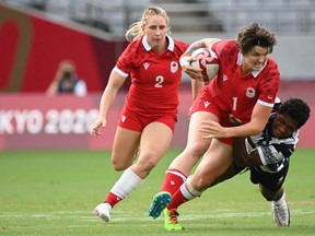 Canada's Brittany Benn of Napanee is tackled by Fiji's Ana Maria Naimasi in a women's pool B rugby sevens match between Canada and Fiji during the 2020 Tokyo Olympic Summer Games at Tokyo Stadium on Thursday.