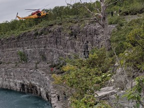 A military helicopter hovers over a search and rescue technician during the rescue of a man from the Marmora mine  Sunday.