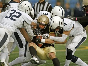 Edmonton Huskies defensive back Wes Bookland is swarmed by Edmonton Wildcats during Canadian Junior Football League Prairie Football Conference game action in Edmonton on Sunday October 14, 2018. The Huskies defeated the Wildcats by a score of 42-17. (PHOTO BY LARRY WONG/POSTMEDIA)