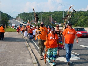 Patricia Ballantyne and Nipissing First Nation Chief Scott McLeod lead the march along Algonquin Avenue, Monday.
PJ Wilson/The Nugget