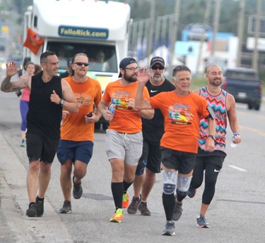 Sonny Spina (left) helps Rick Fall wrap up his cross-country run on Saturday, Aug. 7, 2021 in Sault Ste. Marie, Ont. (BRIAN KELLY/THE SAULT STAR/POSTMEDIA NETWORK)