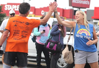 Rick Fall wraps up his cross-country run on Saturday, Aug. 7, 2021 in Sault Ste. Marie, Ont. Fall is congratulated by a well-wisher.(BRIAN KELLY/THE SAULT STAR/POSTMEDIA NETWORK)