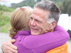 Rick Fall wraps up his cross-country run on Saturday, Aug. 7, 2021 in Sault Ste. Marie, Ont. Fall is hugged by well-wisher at Christie's RV on Great Northern Road. (BRIAN KELLY/THE SAULT STAR/POSTMEDIA NETWORK)