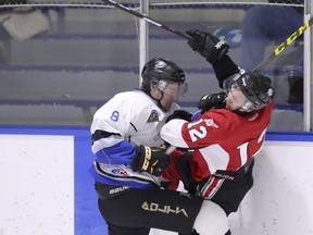 Former Thunder forward Tyler Perkins (right) collides with Lightning's DJ Kistner as the Airdrie Techmation Thunder beat the Stettler Lightning 3-1 in Heritage Junior Hockey League action at the Ron Ebbesen Arena on Friday, Jan 8, 2016 in Airdrie, Alta.