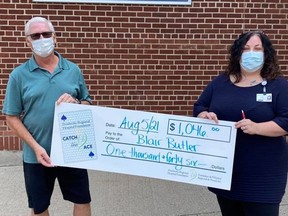 Pembroke Regional Hospital Foundation community fundraising specialist Leigh Costello, right, presents Blair Butler with his week two winning weekly prize amount of $1,046.