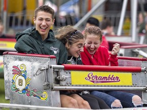 Eric Semiwolos, Nicole Purificati and Hailey Hunt (right) enjoy a ride on the Scrambler, one of the Campbell Amusements rides at the midway of the Paris Fair on Sunday September 1, 2019 in Paris. Brian Thompson