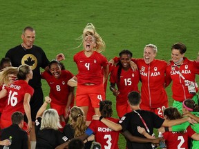 The members of the Canadian women's soccer team celebrate after winning the penalty shootout and the gold medal on Aug. 6 the 2020 Tokyo Olympics. REUTERS/Carlos Barria