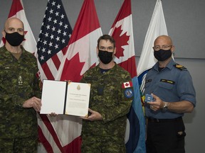 Lieutenant-General Wayne Eyre (left) presents Lieutenant Colonel Joseph Oldford with the Chief of Defence Staff Commandation, accompanied by Chief Warrant Officer Gilles Gregoire (rigLt.-Gen. Wayne Eyre, left, acting Chief of the Defence Staff, presents Lt.-Col. Joseph Oldford, commanding officer of 21 Aerospace Control and Warning Squadron, with the Chief of Defence Staff Commendation, accompanied by Chief Petty Officer First Class Gilles Gregoire.
Cpl. Rob Ouellette, 22 Wing Imagery Technician