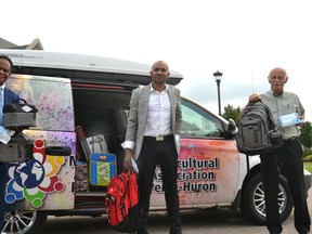 Volunteers with the Multicultural Association of Perth Huron are collecting donations of backpacks, school supplies, clothing and other necessities to give to local newcomer kids and other students in need as they prepare to head back to school in September. Pictured from left are multicultural association founder Dr. Gezaghn Wordofa, volunteer and board member Emmanuel Munisi, and volunteer Steve Landers. Galen Simmons/The Beacon Herald/Postmedia Network