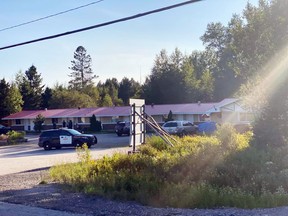 Police are seen at a motel on Highway 11 North, Monday. Submitted Photo
