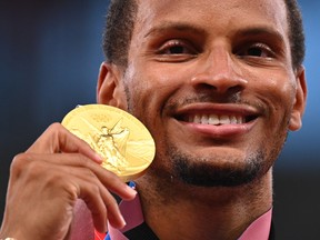 Gold medallist, Andre De Grasse of Canada poses as he celebrates on the podium REUTERS/Dylan Martinez