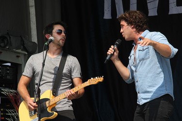 Chase Kasner, right, and Chris McComb of the River Town Saints performing on stage in Pembroke at an outdoor concert at Riverside Park on Aug. 7.