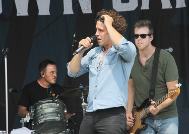 River Town Saints bass player Joe Patrois (right), vocalist Chase Kasner (centre) and drummer Jordan Potvin on stage in Pembroke at an outdoor concert on Saturday, Aug. 7.