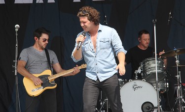 River Town Saints guitarist Chris McComb (left), vocalist Chase Kasner (centre) and drummer Jordan Potvin on stage in Pembroke at an outdoor concert on Saturday, Aug. 7.