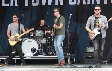 From left, River Town Saints guitarist Chris McComb, drummer Jordan Potvin, bass player Joe Patrois and guitarist Jeremy Bortot on stage in Pembroke at an outdoor concert on Saturday, Aug. 7.