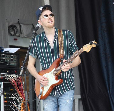 Lemon Cash lead guitarist Joel Ryan performing on stage in Pembroke at an outdoor concert on Aug. 7.