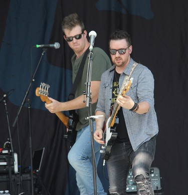 River Town Saints guitarist Jeremy Bortot (right) and bassist Joe Patrois on stage in Pembroke at an outdoor concert on Saturday, Aug. 7.