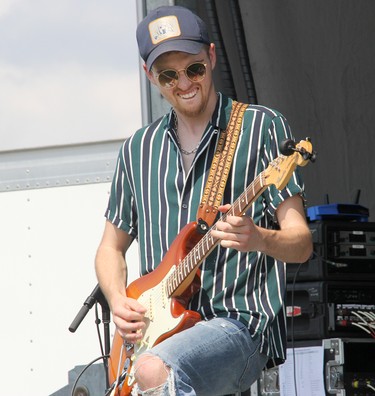 Lemon Cash lead guitarist Joel Ryan performing on stage in Pembroke at an outdoor concert on Aug. 7.