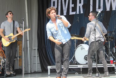The River Town Saints featuring Chris McComb (left), Chase Kasner (centre) and Jeremy Bortot on stage in Pembroke performing at a drive-in outdoor concert held in Riverside Park on Aug. 7.