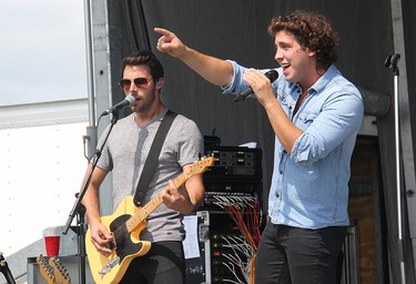 Chase Kasner, right, and Chris McComb of the River Town Saints performing on stage in Pembroke at an outdoor concert at Riverside Park on Aug. 7.