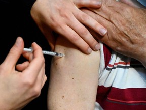 A person receives a COVID-19 vaccine.