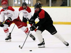 Team Griffith's Ian Campbell, right, is pursued by Team Krieger's Brayden DeGelas and Cam Symons during a round-robin game in the Athletes' Fuel Cup hockey tournament at Thames Campus Arena in Chatham, Ont., on Thursday, Aug. 19, 2021. Mark Malone/Chatham Daily News/Postmedia Network