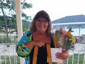 Port Elgin Beach Preservers co-founder Patricia Corrigan-Frank received flowers, a gift certificate and a life preserver memento from family and friends in thanks for her spearheading opposition to the proposed Cedar Crescent Village proposal, just steps from the McGrath Pavilion on the Port Elgin waterfront where Corrigan-Frank was honoured August 19.