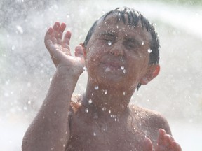 Theodore Coccimiglio, 8, enjoys the splash pad at Bellevue Park in Sault Ste. Marie, Ont., on Friday, Aug. 20, 2021. He is visiting the city from Windsor, Ont. (BRIAN KELLY/THE SAULT STAR/POSTMEDIA NETWORK)